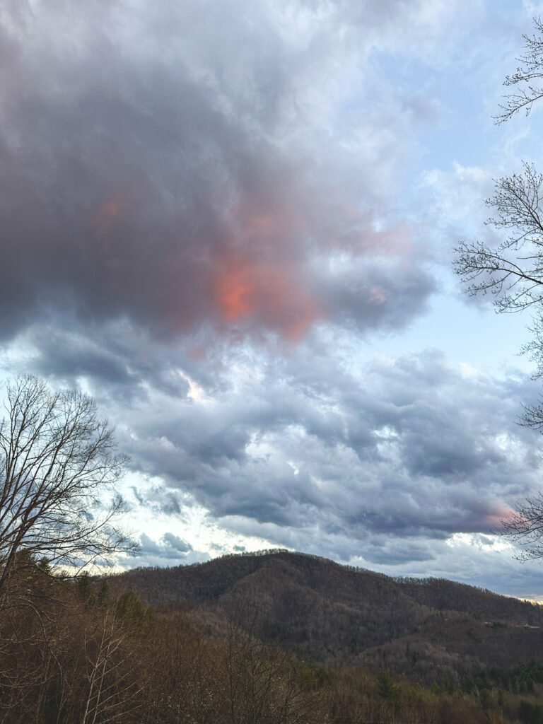 Salmon-colored clouds over an Appalachia mountain, North Carolina, US - Photography by Som Prasad